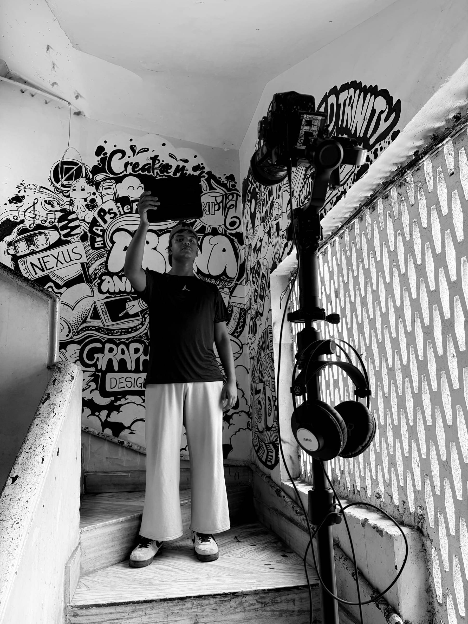 Kaya cinematographer setting up in a stairwell